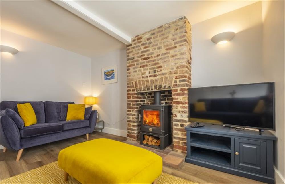 Take a seat by the wood burning stove at Queenie’s Cottage, Wells-next-the-Sea
