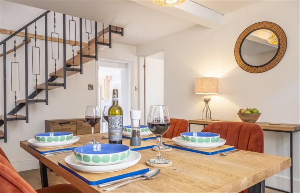 The dining room features stairs to the first floor at Queenie’s Cottage, Wells-next-the-Sea