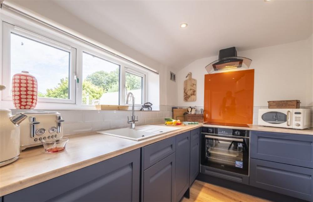 The kitchen has windows overlooking the garden at Queenie’s Cottage, Wells-next-the-Sea