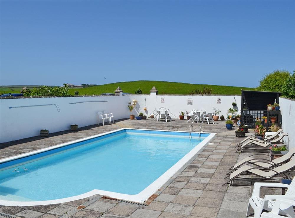 Heated outdoor swimming pool at Barn Cottage, 
