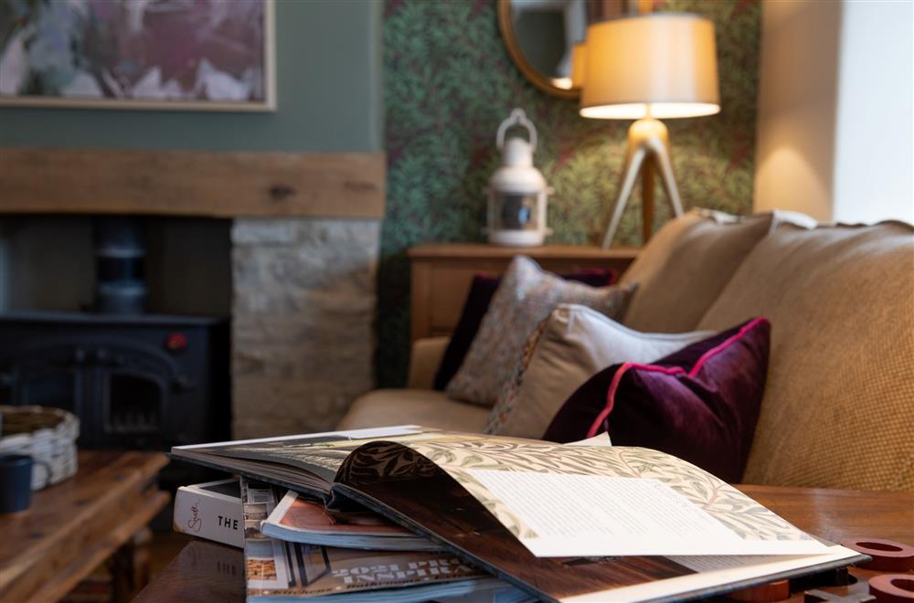 Relax with a book after a day spent exploring the Cotswolds at Radcot Bridge Cottage, Radcot