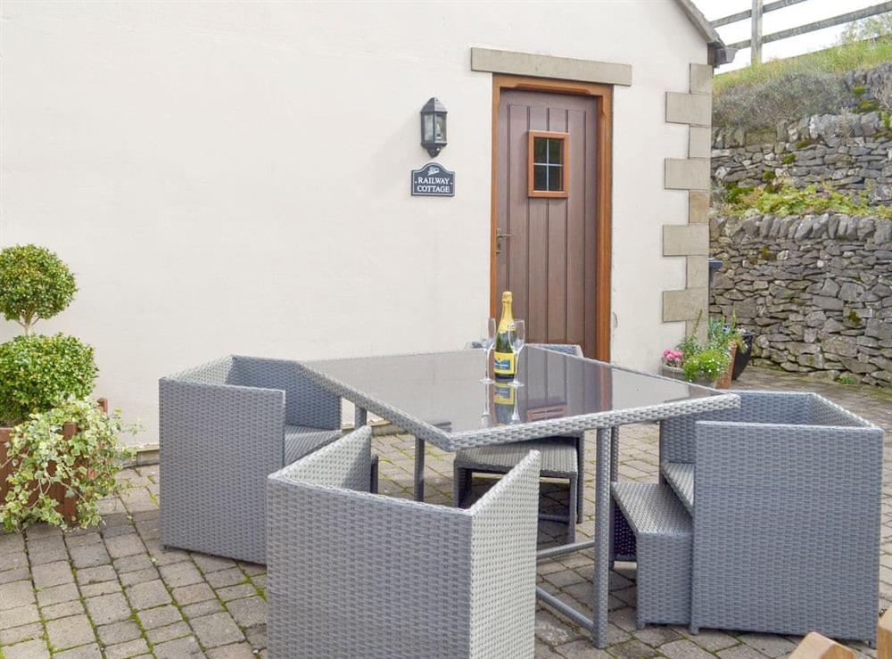 Paved patio with outdoor furniture at Railway Cottage in Longcliffe, near Ashbourne, Derbyshire