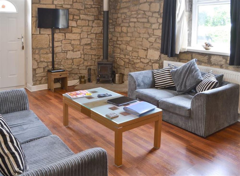 Welcoming living area with wood burner at Stable Cottage, 