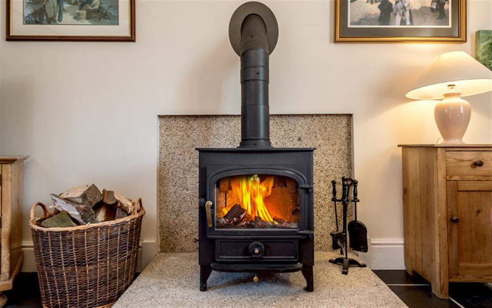 A wood burning stove in the lounge is ideal for cosying up during the colder months.  at Rainbow Cottage in Porthallow