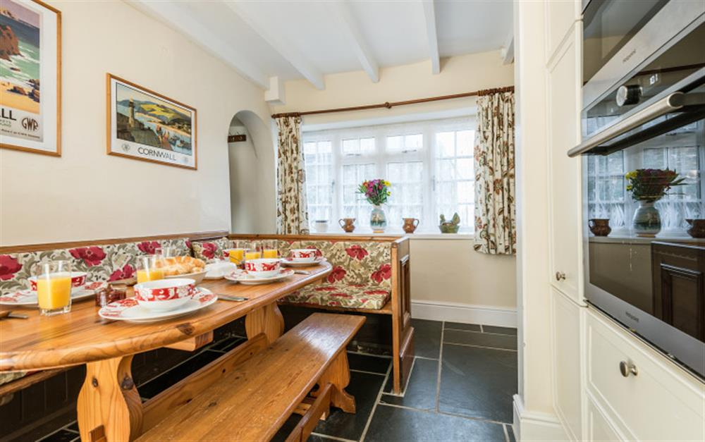 The dining table is spacious enough for everyone to sit comfortably around. at Rainbow Cottage in Porthallow
