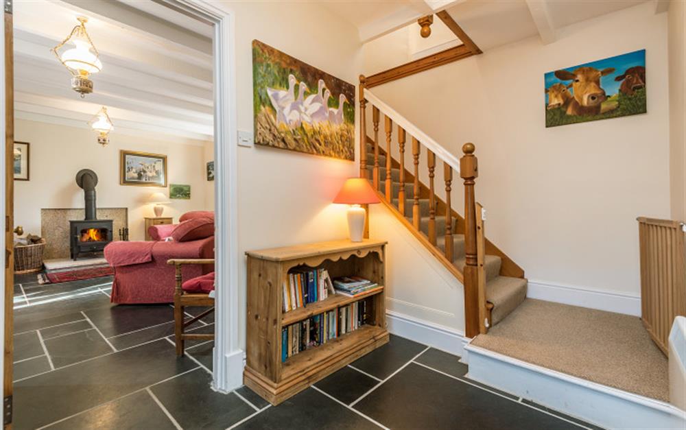 The hallway is inviting and has a nice staircase up to the bedrooms & bathroom. at Rainbow Cottage in Porthallow