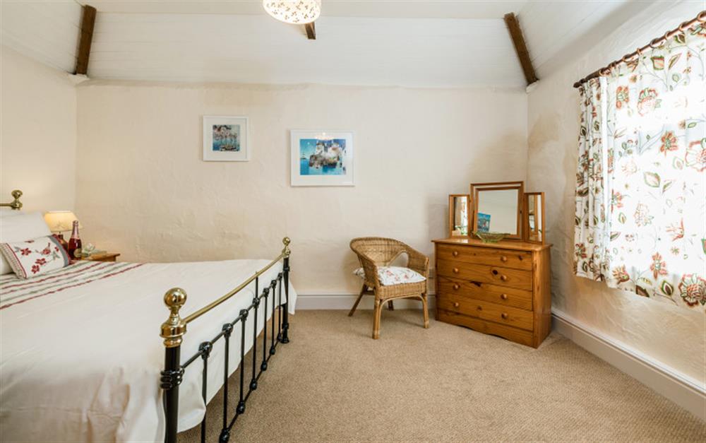 The master bedroom has a 5ft double bed. at Rainbow Cottage in Porthallow