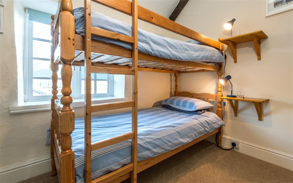 The third bedroom has child size bunks. at Rainbow Cottage in Porthallow