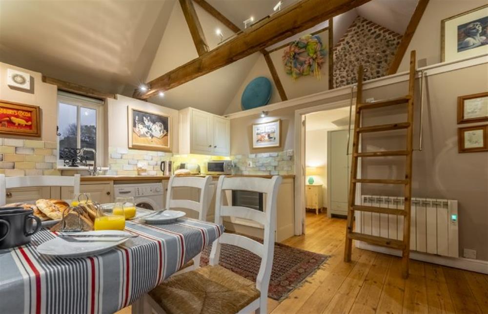Rainbow Cottage: Kitchen table and access to the mezzanine  at Rainbow Cottage, Roughton near Norwich