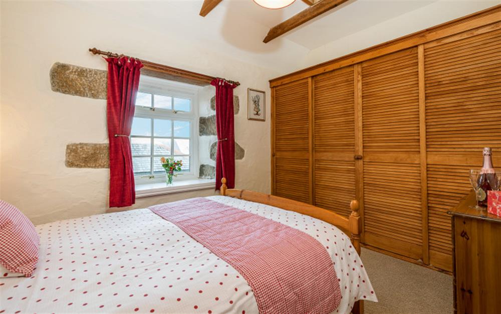 The bedroom has a nice cottagey feel with the pretty bedding and colour scheme. at Rainbow End in Porthallow