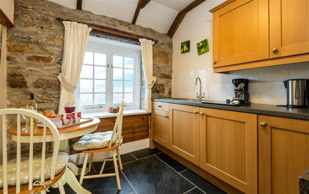 The granite wall in the kitchen adds character. at Rainbow End in Porthallow