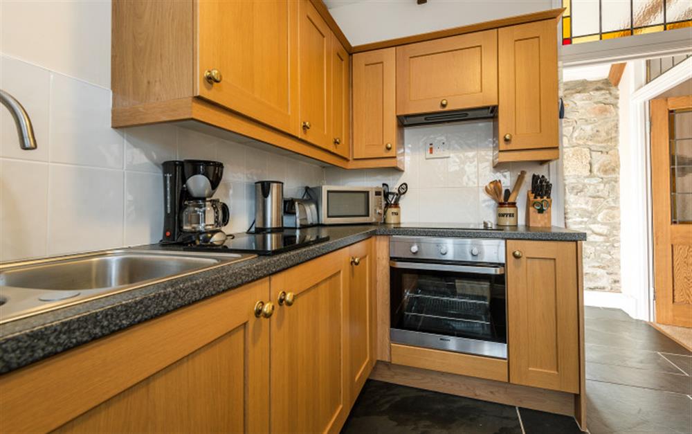 The kitchen is well equipped and has integrated appliances. at Rainbow End in Porthallow