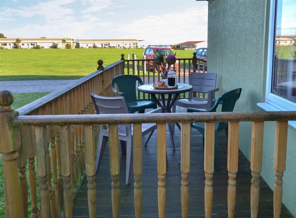 Enclosed decked verandah with garden furniture at Sandy Shore, 