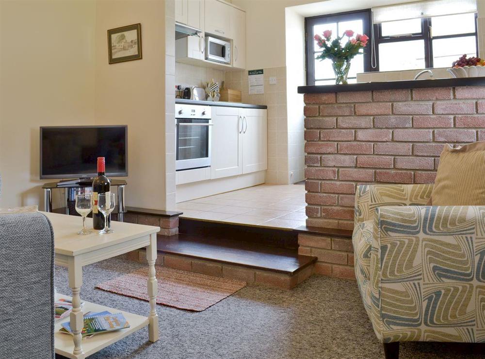Cosy lounge with open aspect to kitchen at Ramscliff Cottage in Nr Wells, Somerset., Great Britain