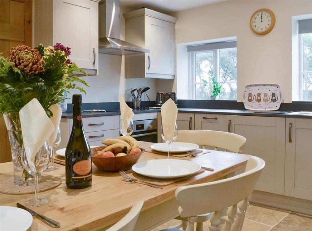Fully equipped kitchen with dining area within the open-plan design at Cow Slip, 