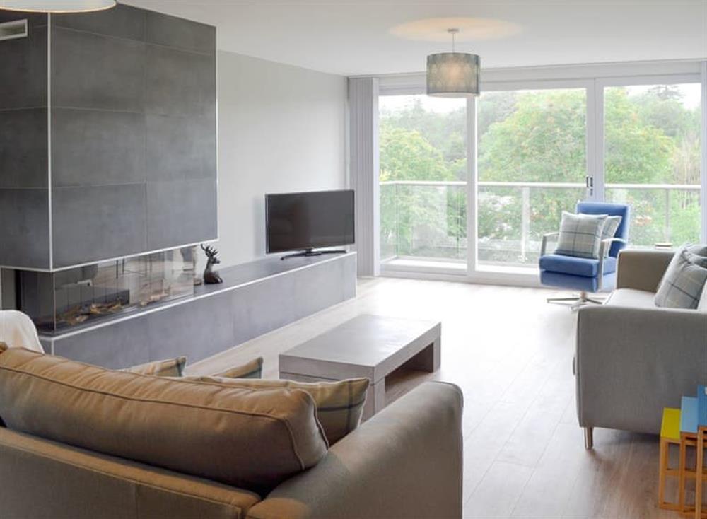 Contemporary living room with sliding doors to balcony at Rayrigg in Bowness-on-Windermere, Cumbria