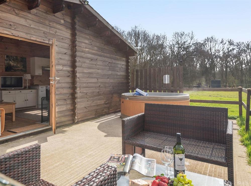 Spacious patio with hot tub and outdoor furniture at Dukes Wood, 