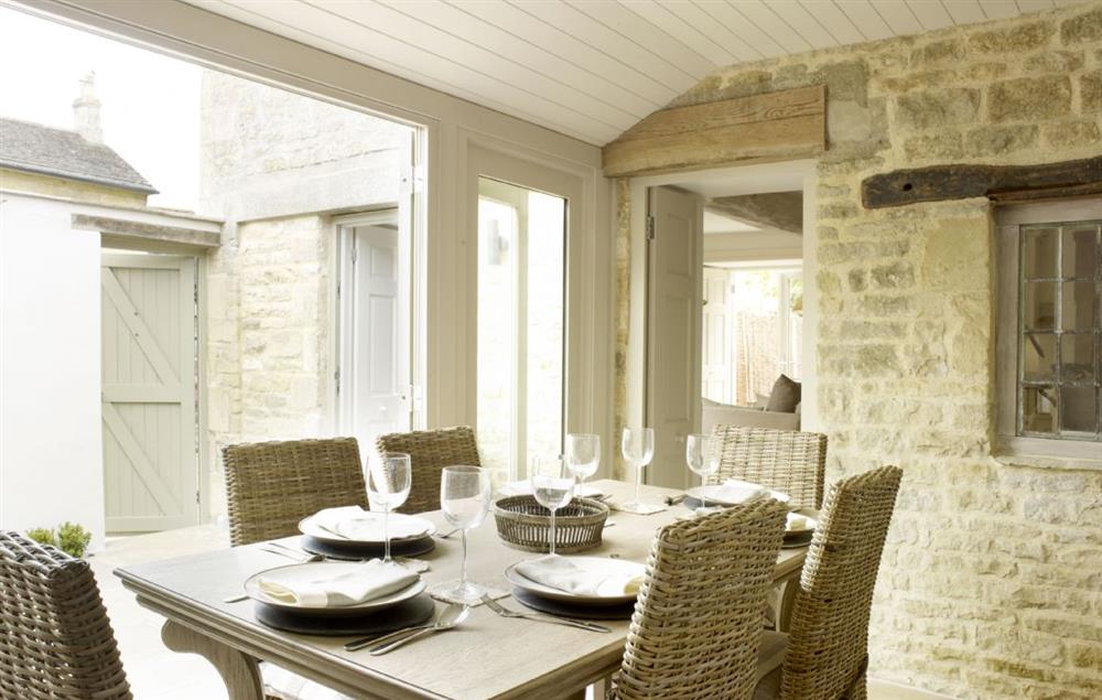 Dining room with French doors opening on the the courtyard garden at Rectory Cottage, Tinwell