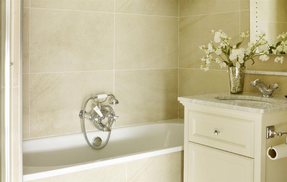 En-suite bathroom with bath and separate walk in shower at Rectory Cottage, Tinwell