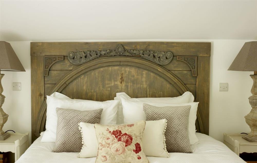 The hand-carved oak headboard completes this romantic space at Rectory Cottage, Tinwell
