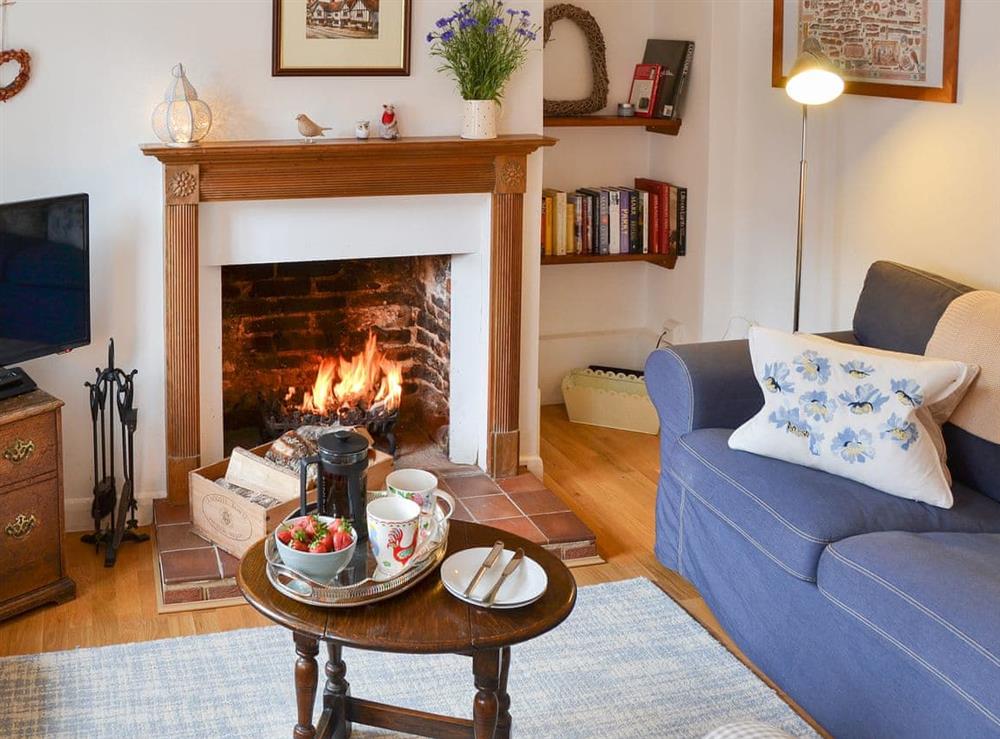 Warm wood-floored living area at Red Brick Cottage in Lavenham, Suffolk