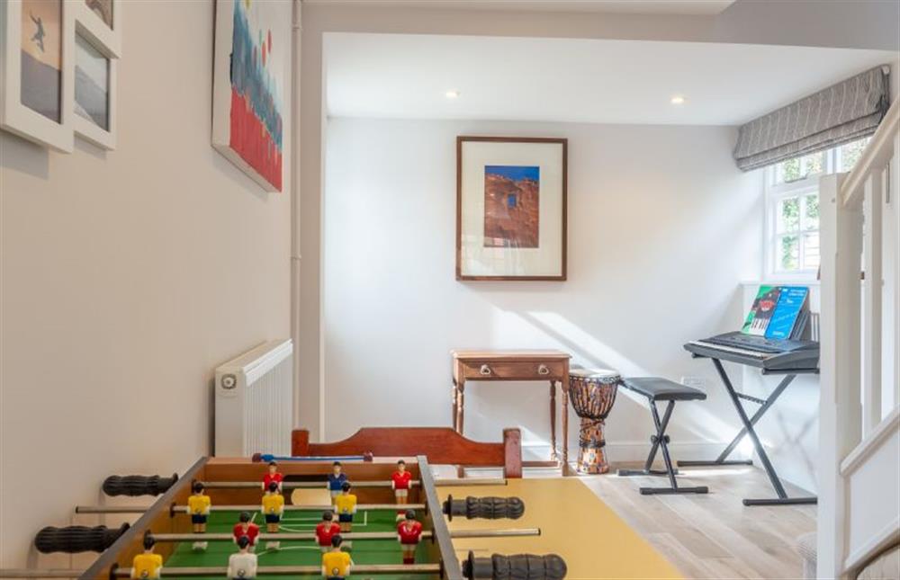 Ground floor: Family room with table football, keyboard and stairs to first floor