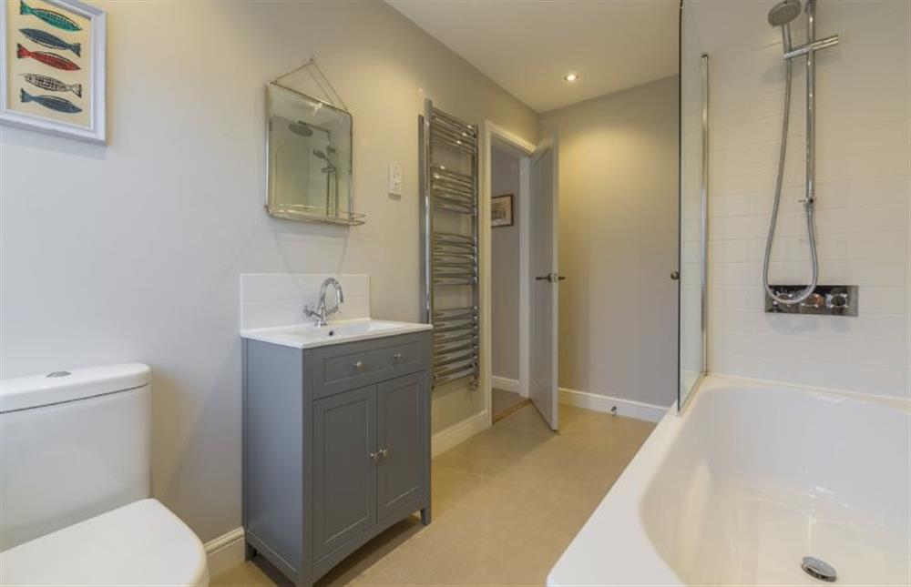 Ground floor: Master bedroom en-suite has bath with shower over at Red Gables, Burnham Market near Kings Lynn