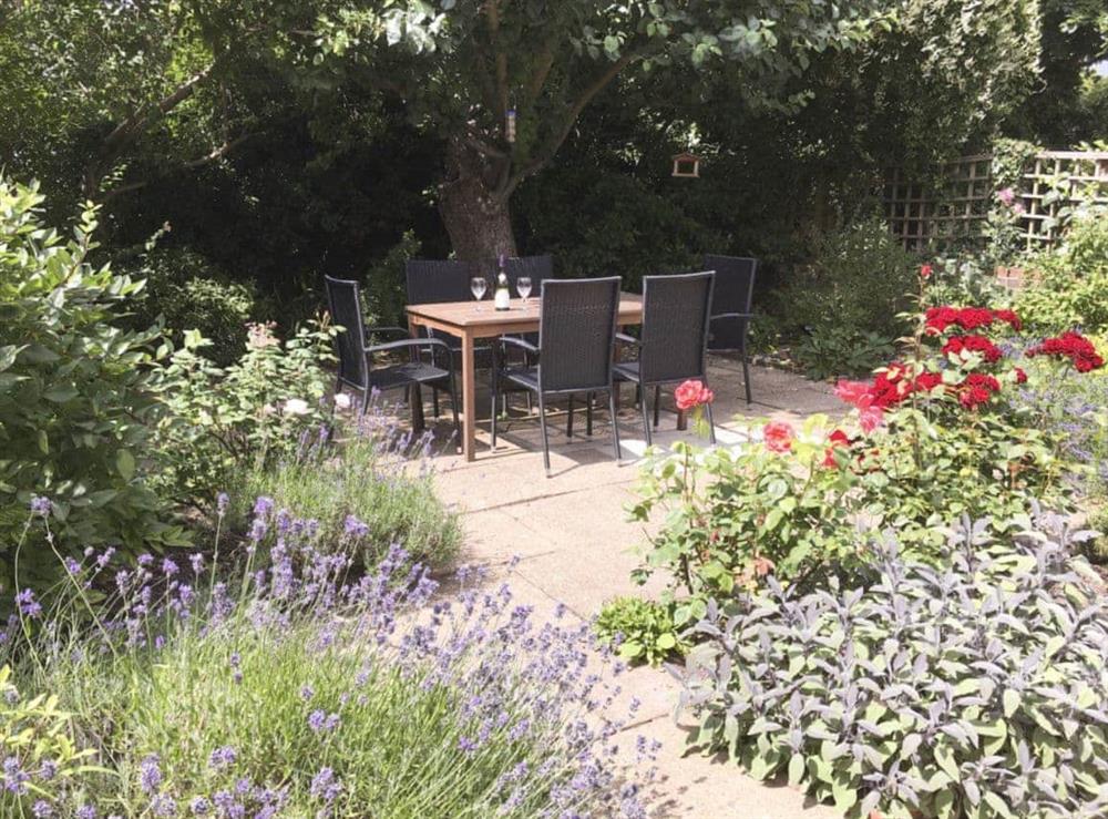 Enclosed paved garden with sitting-out area and furniture at Red Lion Corner in Lavenham, Suffolk