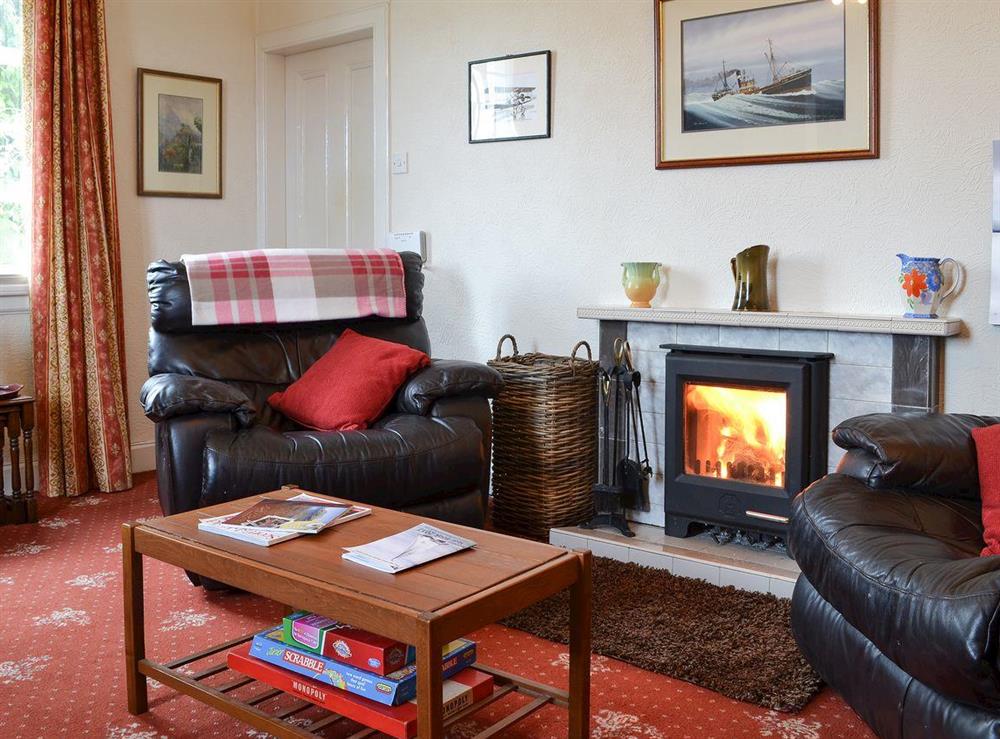Relaxing living room with wood burner (photo 2) at Red Lodge in near Oban, Argyll