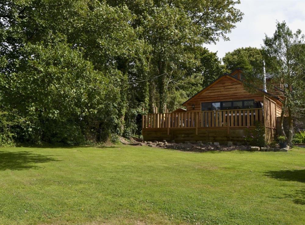 Enclosed garden with decking area and garden furniture at Red Squirrel Cottage in Whitwell, near Ventor, Isle of Wight