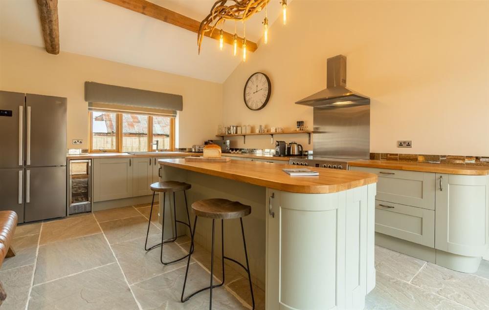 A spacious kitchen with a centre island, vast handmade kitchen table and bespoke antler chandelier makes entertaining easy
