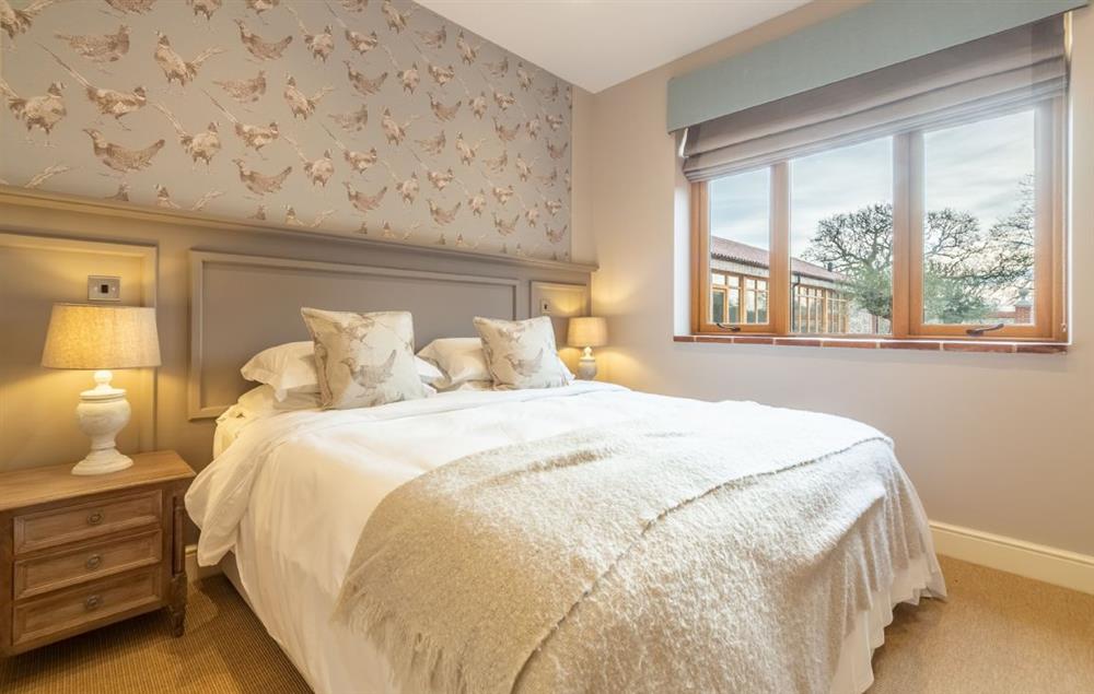 bedroom with 5’ king-size bed and en-suite shower room at Red Stag Lodge, Little Massingham