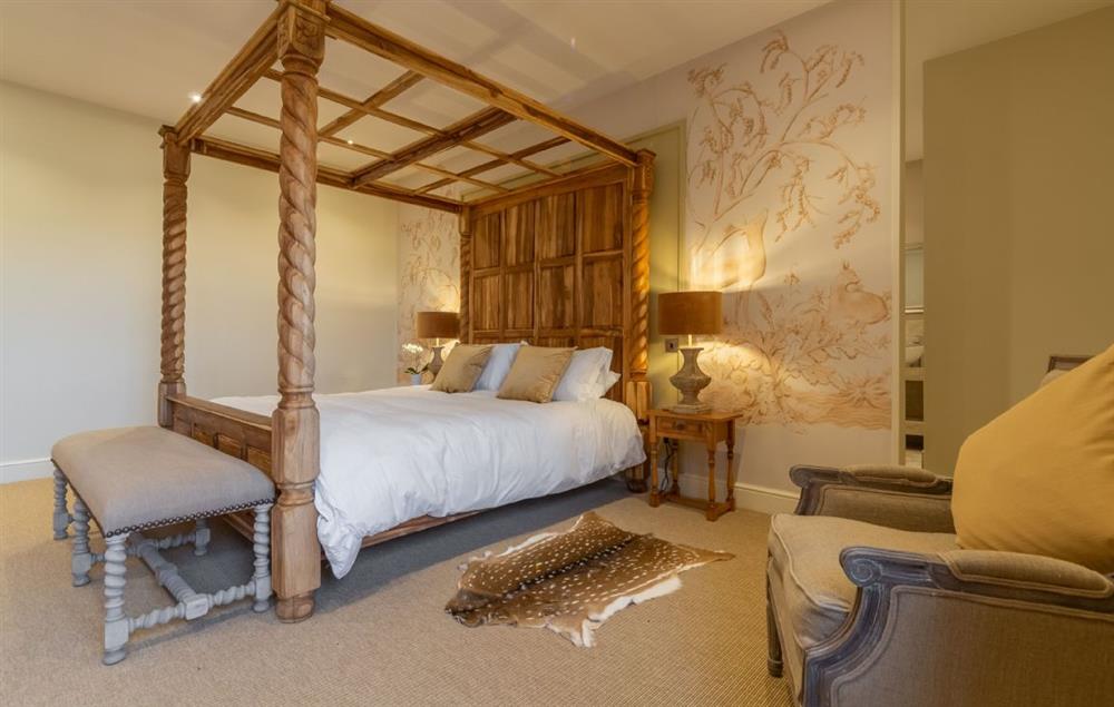 Master bedroom with 6’ super king-size four poster bed with views into the deer park. (photo 2) at Red Stag Lodge, Little Massingham