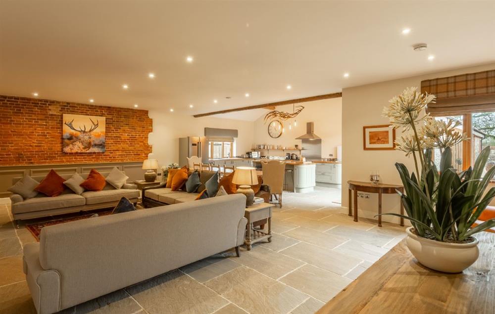 The spacious open plan living area with wood burning stove at Red Stag Lodge, Little Massingham