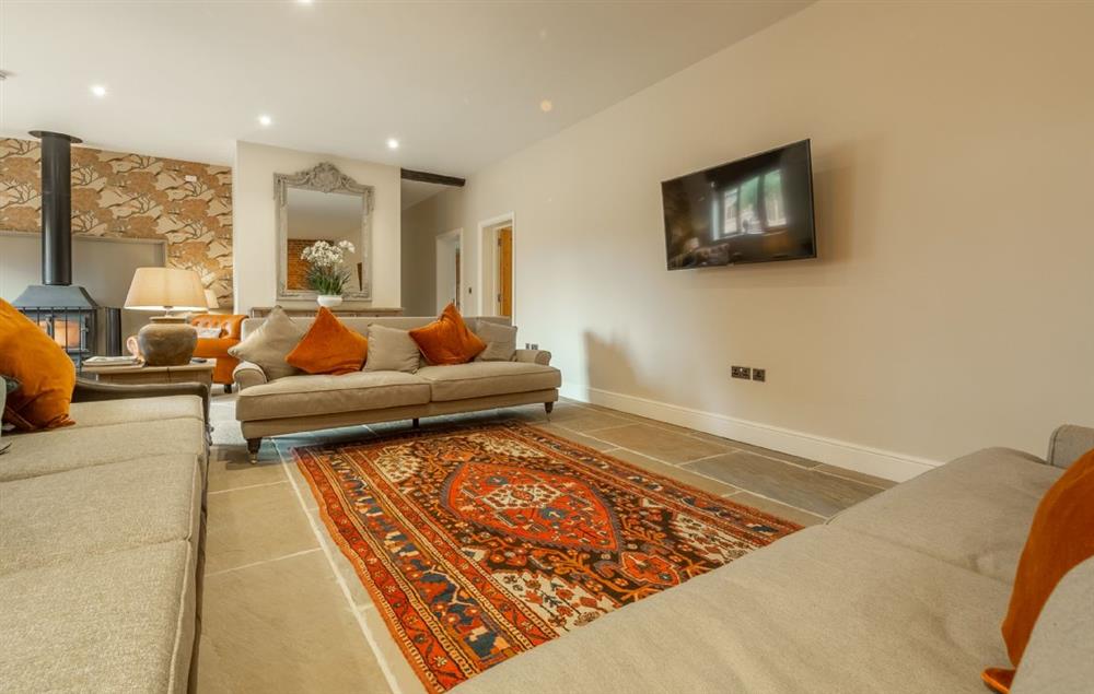 The spacious sitting room in the large living area with wood burning stove (photo 3) at Red Stag Lodge, Little Massingham