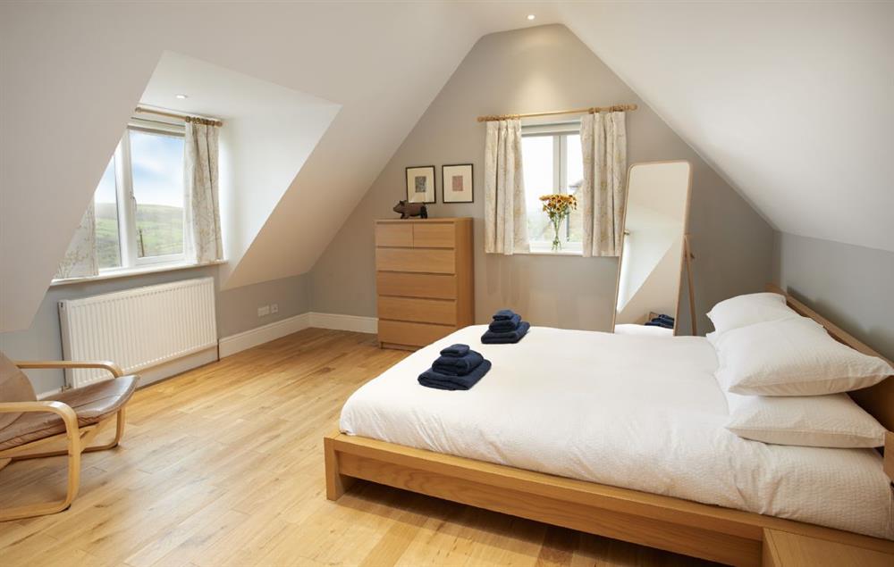Master bedroom with king-size bed and en-suite shower room at RedRoofs, Aislaby
