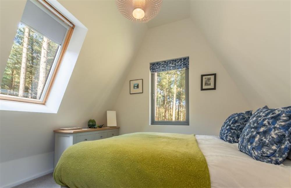 First floor: Dual aspect master bedroom at Reedcutter Lodge, Weybourne near Holt