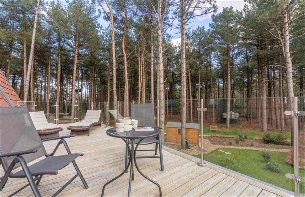 First floor: Upper decked area with woodland views at Reedcutter Lodge, Weybourne near Holt
