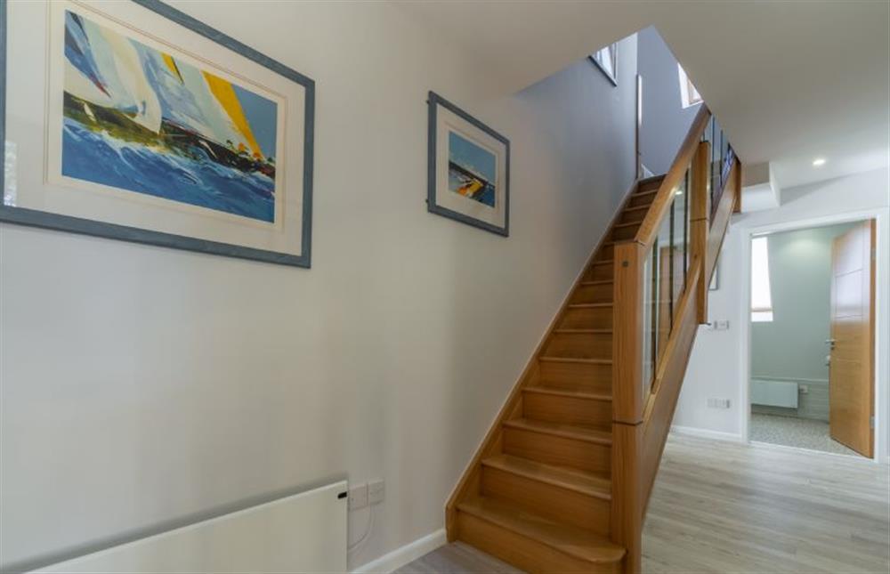 Ground floor: Stairway to first floor at Reedcutter Lodge, Weybourne near Holt
