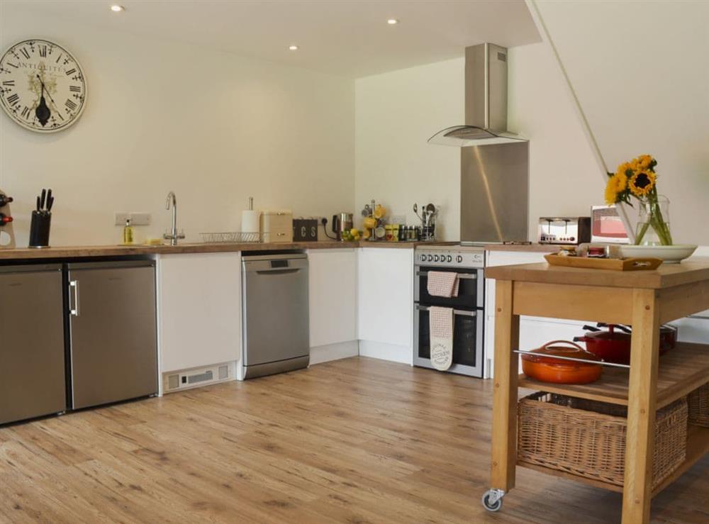 Well-equipped kitchen area at Reeds Farmhouse in Farnham, Hampshire