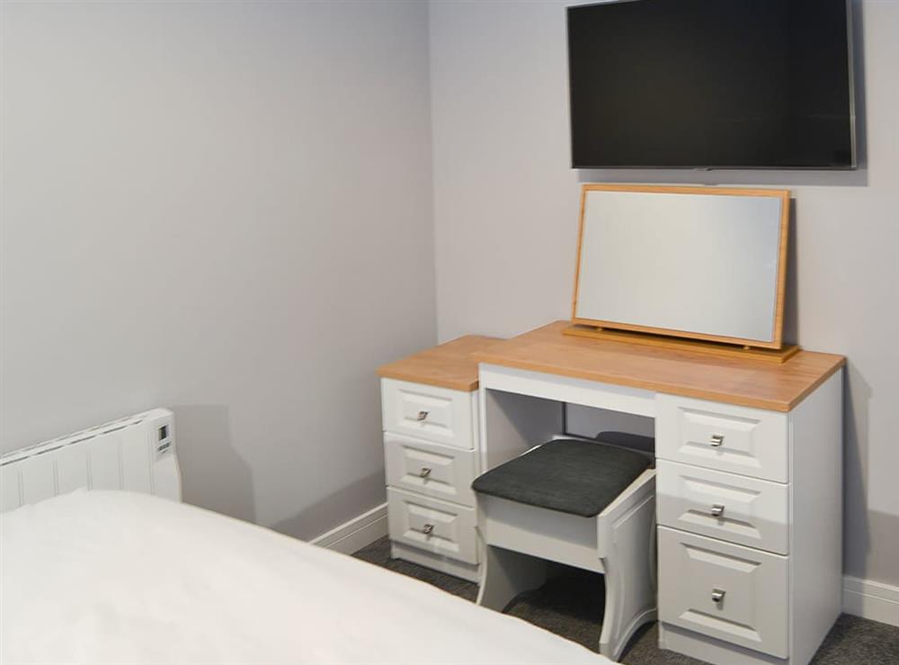 Double bedroom with charming dressing table and flatscreen tv at Apartment 2, 