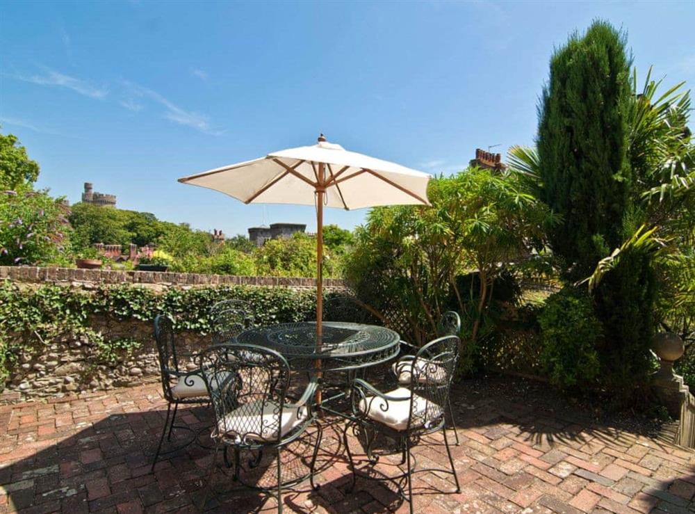 Relaxing enclosed patio garden with furniture at Regents House in Arundel, West Sussex., Great Britain