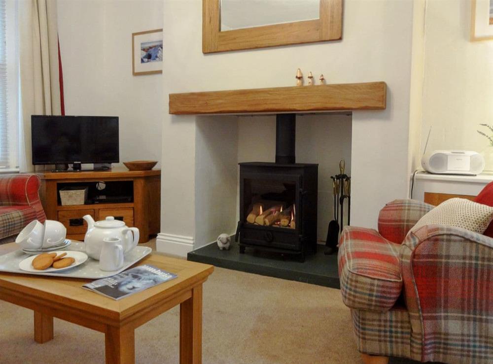 Cosy wood burner in the living area at Retreat (The) in Keswick, Cumbria