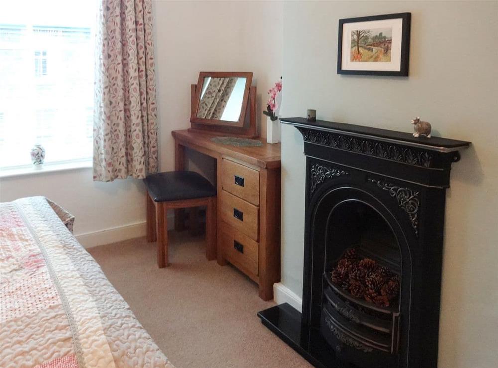 Double bedroom with feature cast iron fireplace at Retreat (The) in Keswick, Cumbria