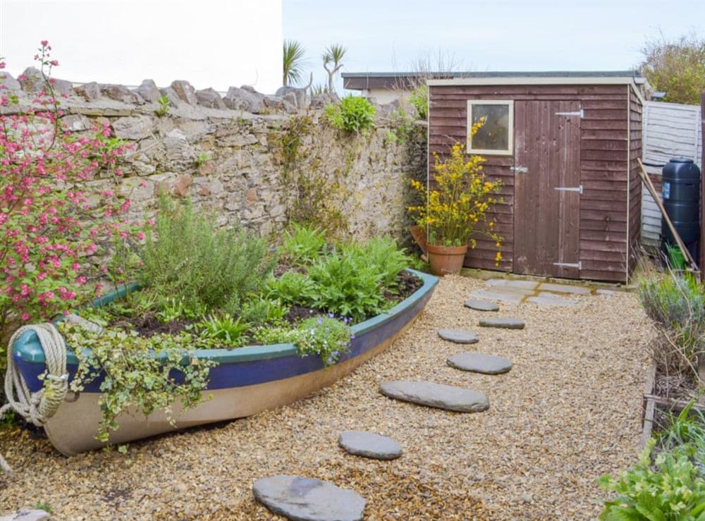 Enclosed courtyard with sitting out area at Revels Retreat in Brixham, Devon
