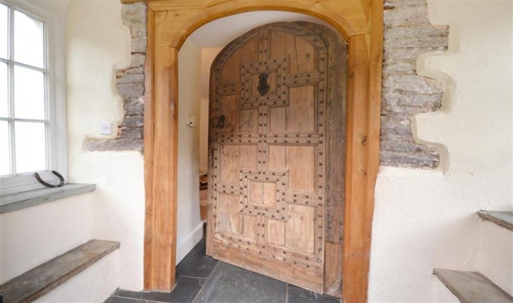 The front entrance, with 17th century studded door, originally from St Peter's Church on the cliff tops. at Revelstoke Park House in Noss Mayo