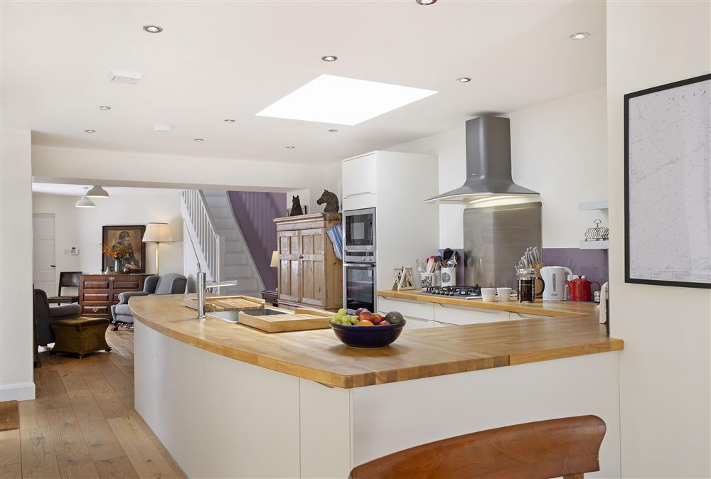 Ground floor: Open-plan living space with well-equipped kitchen leading to seating area at Rexton House, Llantwit Major