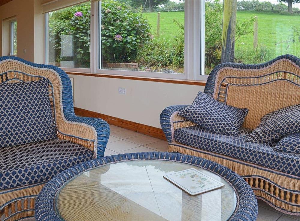 Comfortable seating ni the conservatory at Rhandir-Mwyn in Caernarfon, Gwynedd