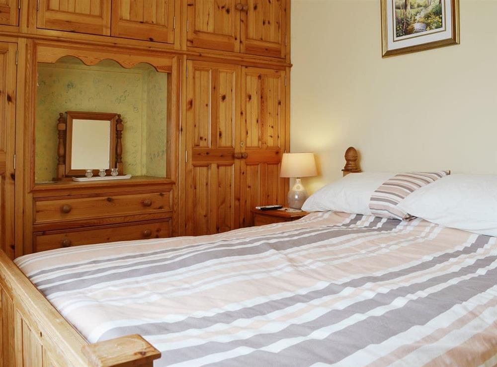 Double bedroom with fitted wardrobes and dressing area at Rhandir-Mwyn in Caernarfon, Gwynedd