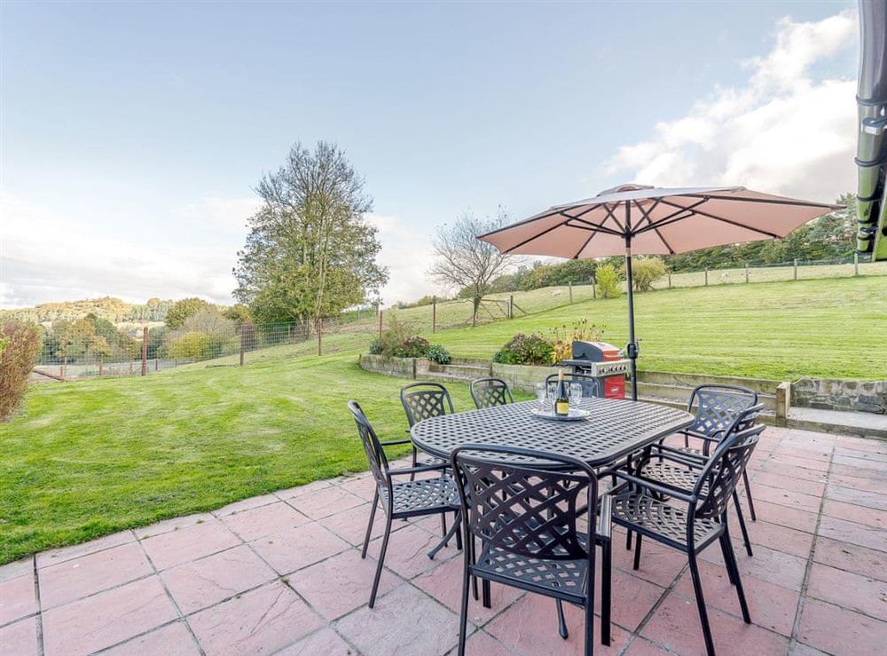Enclosed lawned garden with patio, garden furniture and BBQ at Rhiew Bank in Bwlch-y-ffridd, near Newtown, Powys